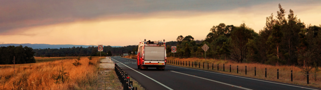 Fire truck travelling on a rural road.