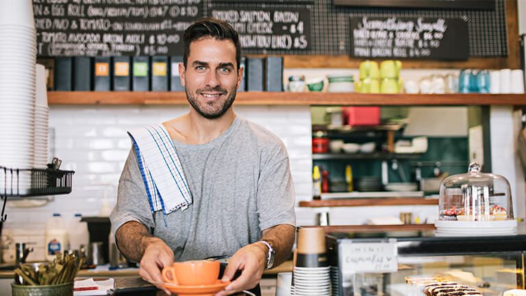 Cafe owner serving you coffee.